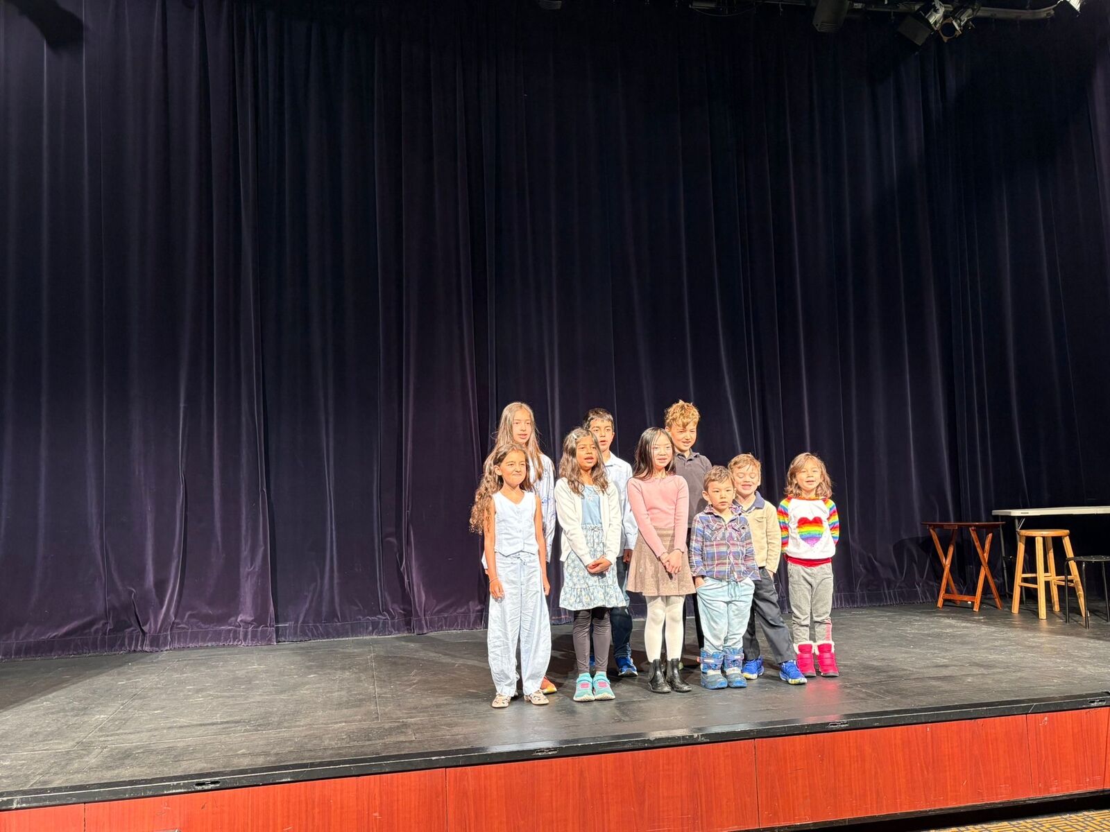 Students lined up on stage during a showcase